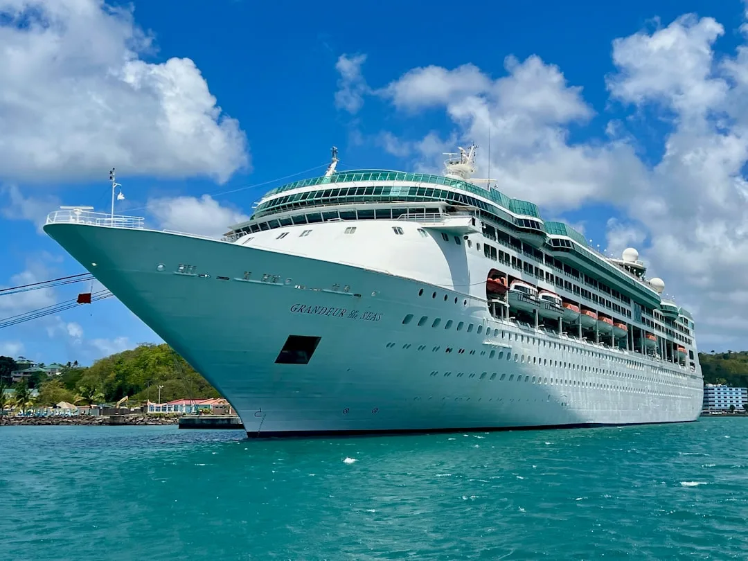 Large cruise ship docked in bright blue water for an adult couples cruise holiday.