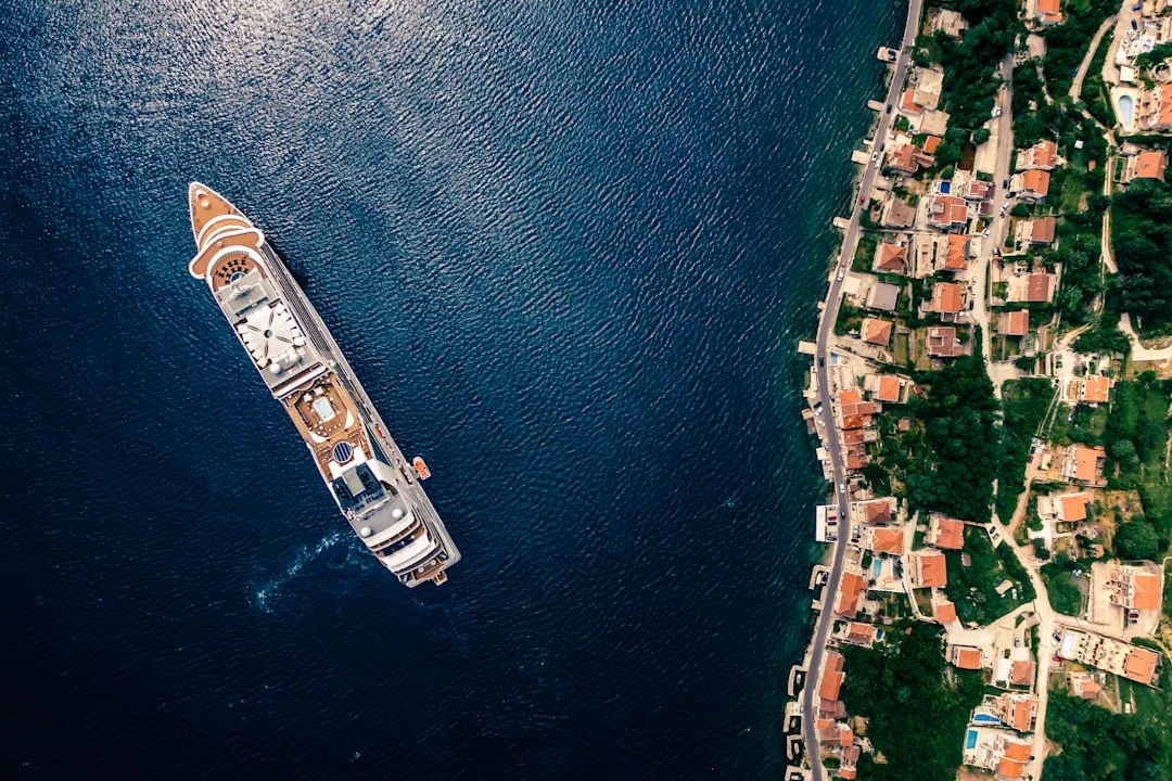 Cruise ship sailing through blue water for a Cunard price drop alerts guide.