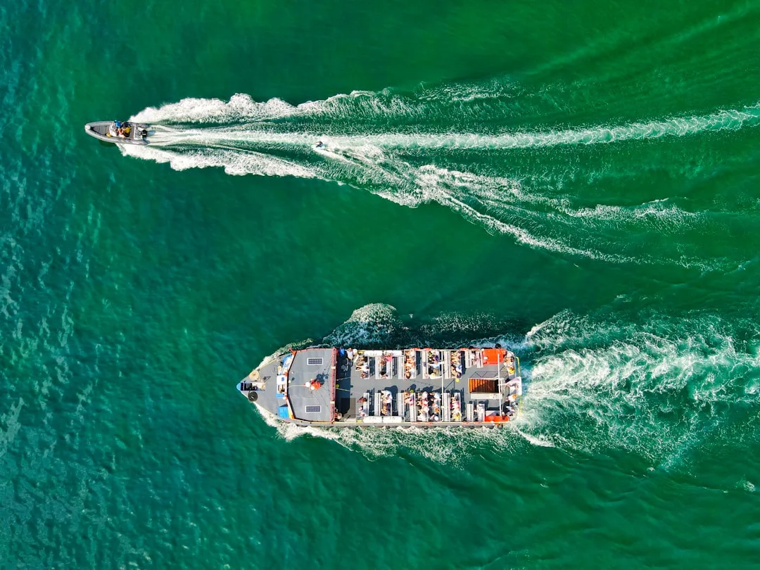 white and black ship on sea during sunset