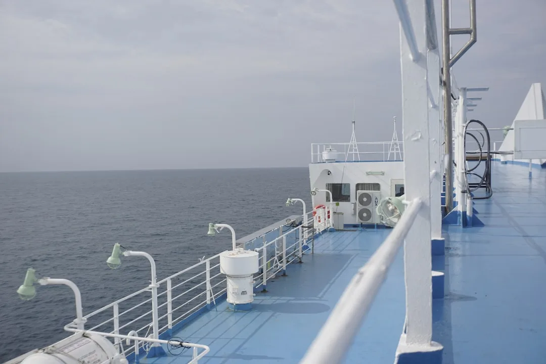 white cruise ship on sea under white clouds and blue sky during daytime